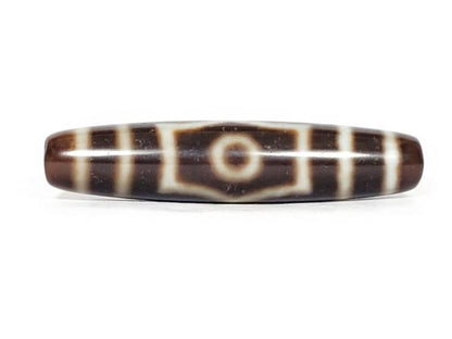 A vintage Dzi bead with a mesmerizing Three Eye Motif. This authentic artifact, identified as TD-ThE-003, showcases the intricate craftsmanship and spiritual symbolism of ancient Dzi beads.