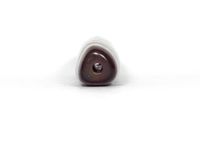 A vintage Dzi bead featuring a rare triangular shape and a captivating Three Eye Motif. This authentic artifact showcases the unique design and spiritual symbolism of ancient Dzi beads
