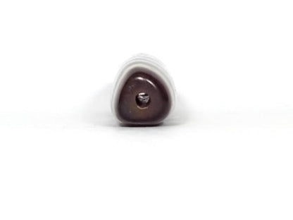 A vintage Dzi bead featuring a rare triangular shape and a captivating Three Eye Motif. This authentic artifact showcases the unique design and spiritual symbolism of ancient Dzi beads